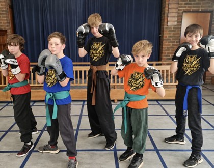 Five young Tiger Strike students standing in training gear