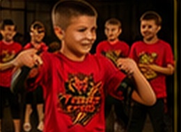 Two young members practising a block in class